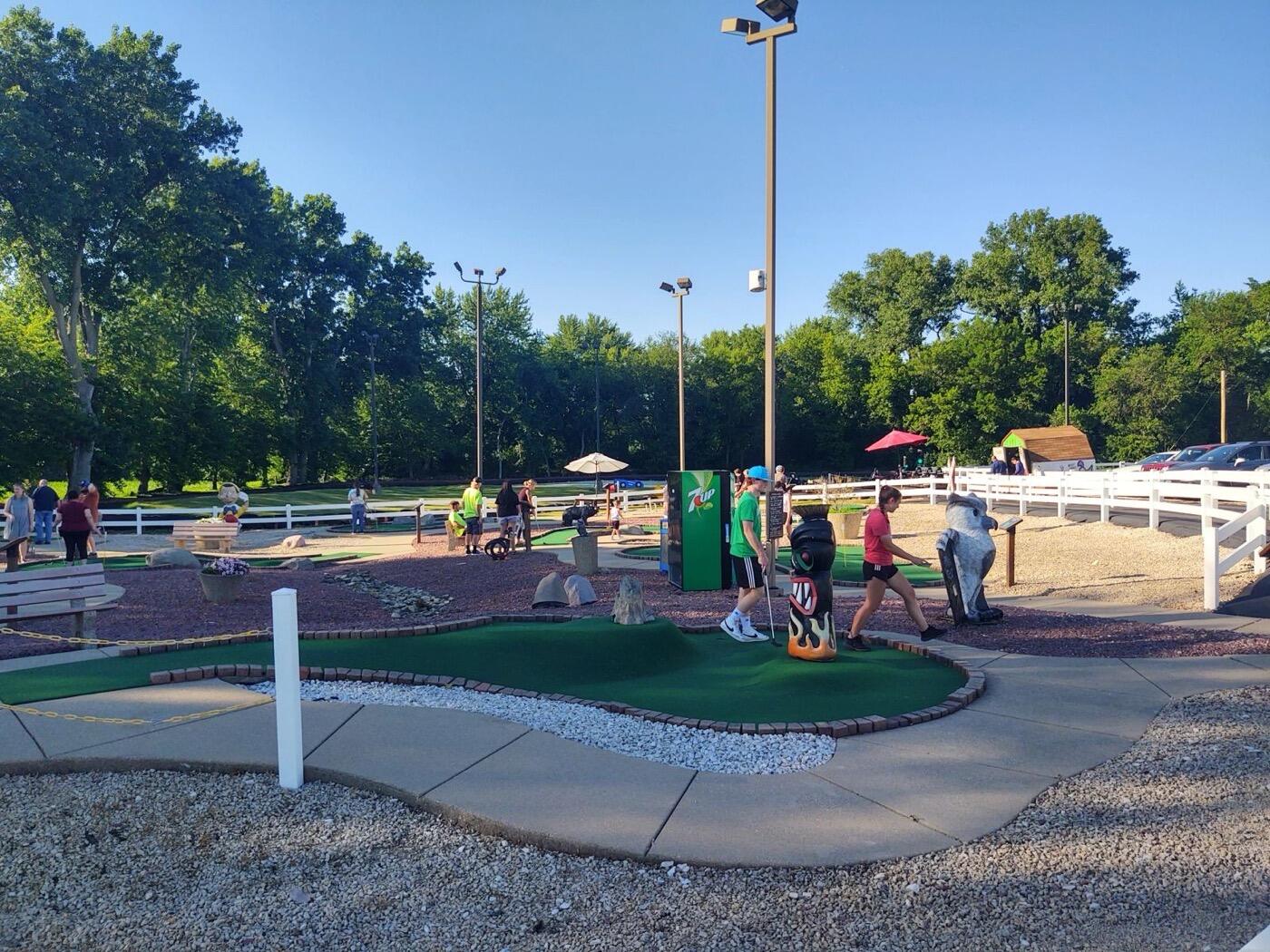 Miniature golf course with players at Sycamore Family Sports Center